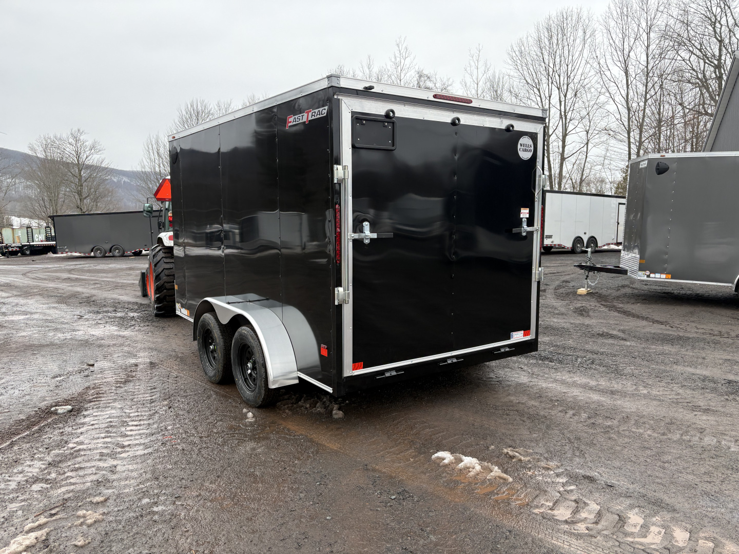 New 2026 Wells Cargo Fasttrac Deluxe 7x12 7K 6'6" Interior Cargo / Enclosed Trailer with rear ramp door