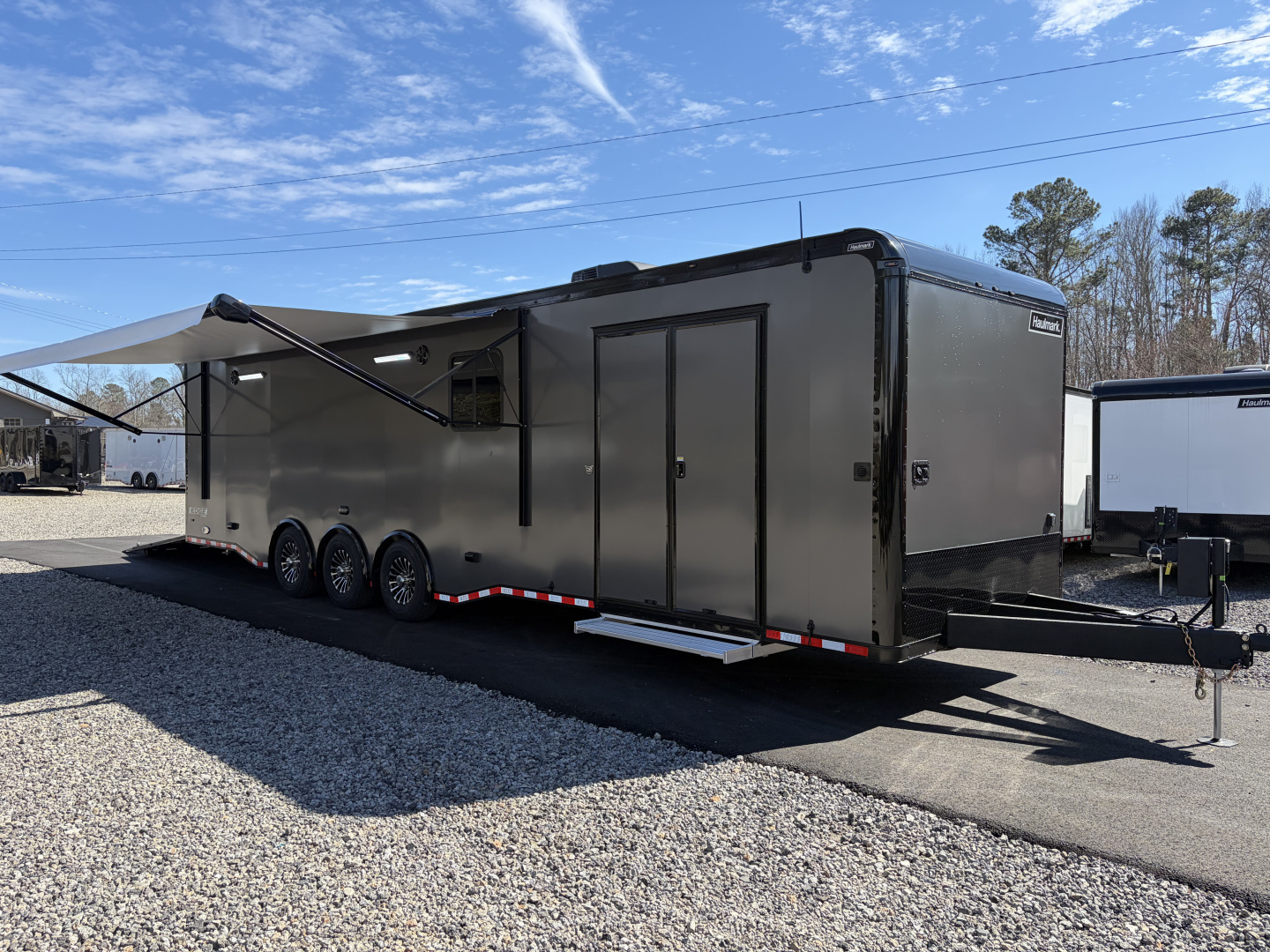 New 2026 Haulmark 34 Bathroom Race Trailer, Air Prep PKG, Awning, Polycor, Insulated, Window, 54" ALX Slide Out Step, A/C + Heat