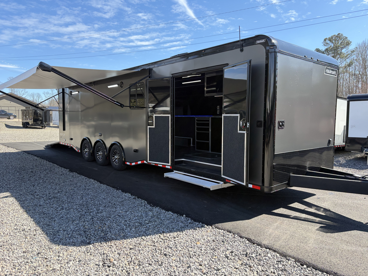 New 2026 Haulmark 34 Bathroom Race Trailer, Air Prep PKG, Awning, Polycor, Insulated, Window, 54" ALX Slide Out Step, A/C + Heat