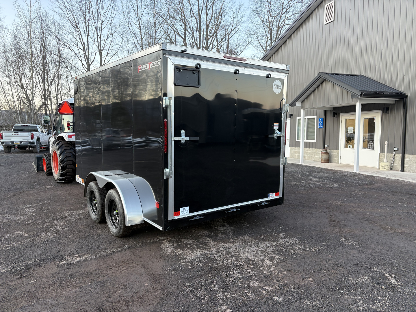 New 2026 WELLS CARGO Fasttrac Deluxe 7x12 7K 6'6" Interior Height Cargo / Enclosed Trailer with Ramp Door