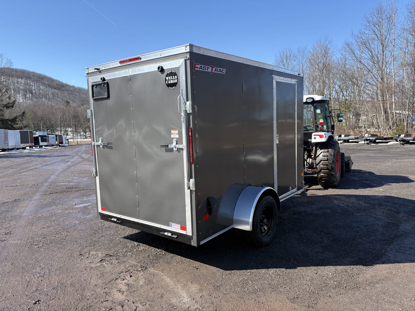 New 2026 WELLS CARGO 6x10 6'6" Interior Height Fasttrac Deluxe Cargo / Enclosed Trailer w/Ramp Door