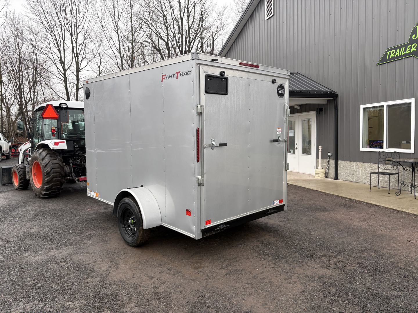 New 2026 Wells Cargo 6x10 6'6" Interior Fasttrac Deluxe Cargo / Enclosed Trailer with Ramp Door