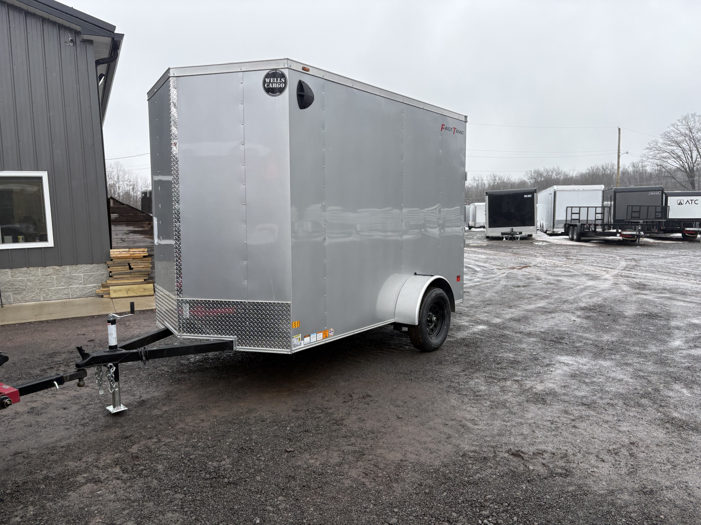 New 2026 Wells Cargo 6x10 7' Interior Height Fasttrac Deluxe with Rear Ramp Door Cargo / Enclosed Trailer