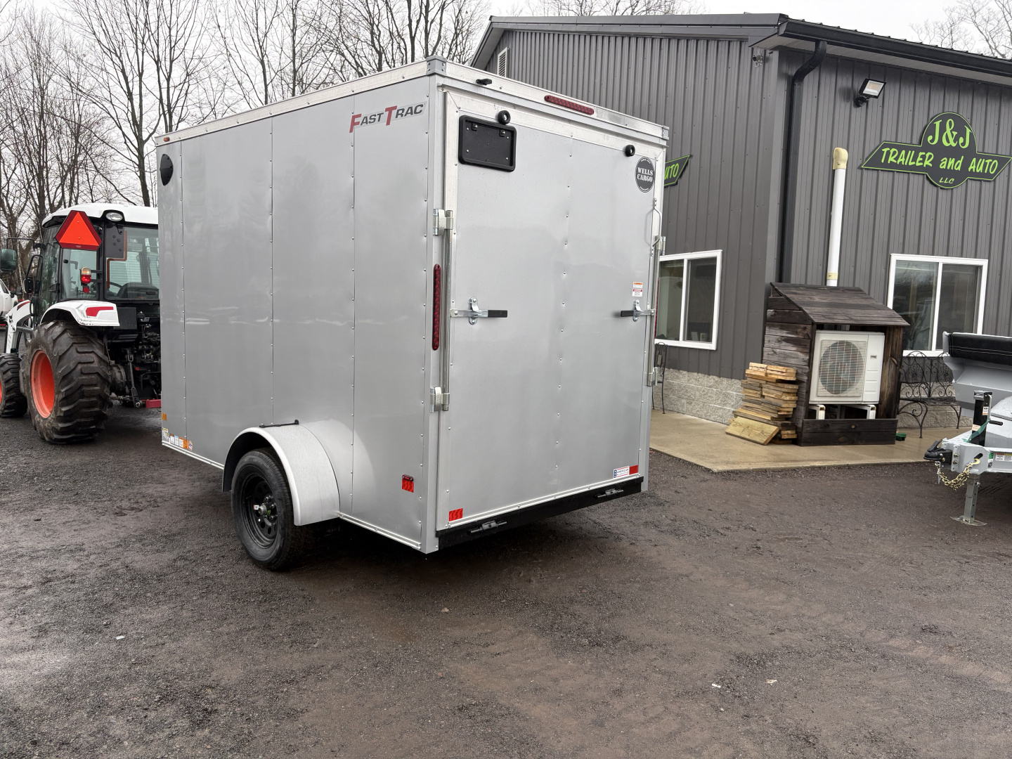 New 2026 Wells Cargo 6x10 7' Interior Height Fasttrac Deluxe with Rear Ramp Door Cargo / Enclosed Trailer