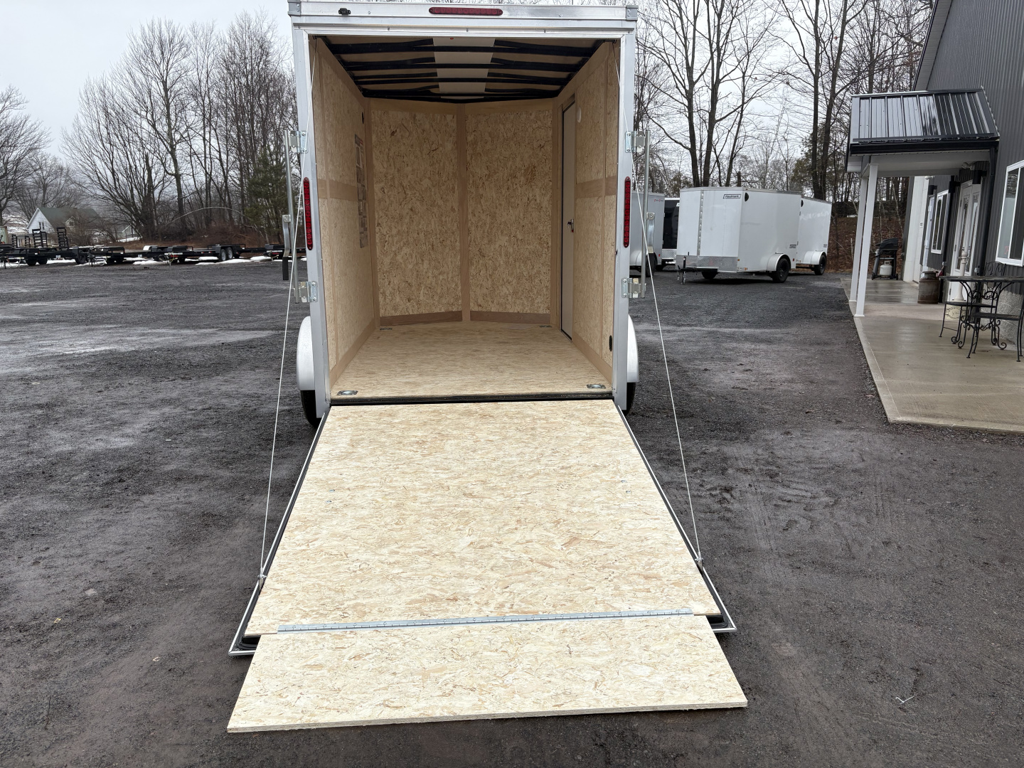New 2026 Wells Cargo 6x10 7' Interior Height Fasttrac Deluxe with Rear Ramp Door Cargo / Enclosed Trailer