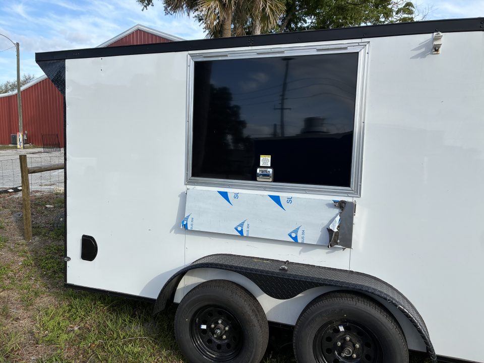 Used 2025 Cargo United LLC Food Truck 7 x 12 Dual Axle White with Blackout Package and Rear Wing with LED Lights Enclosed Trailer
