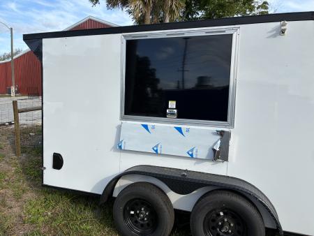 Used 2025 Cargo United LLC Food Truck 7 x 12 Dual Axle White with Blackout Package and Rear Wing with LED Lights Enclosed Trailer