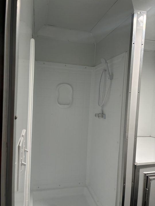 Used 2025 All World Trailers 8.5 X 22 Enclosed Toy Hauler with Murphy Type Bed, Shower, AC, Toilet and Concession Windows