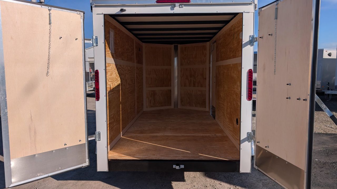 New 2026 Homesteader 6x12 Tandem Intrepid V-Nose Contractor Trailer w/ Rear Barn Doors & Ladder Racks