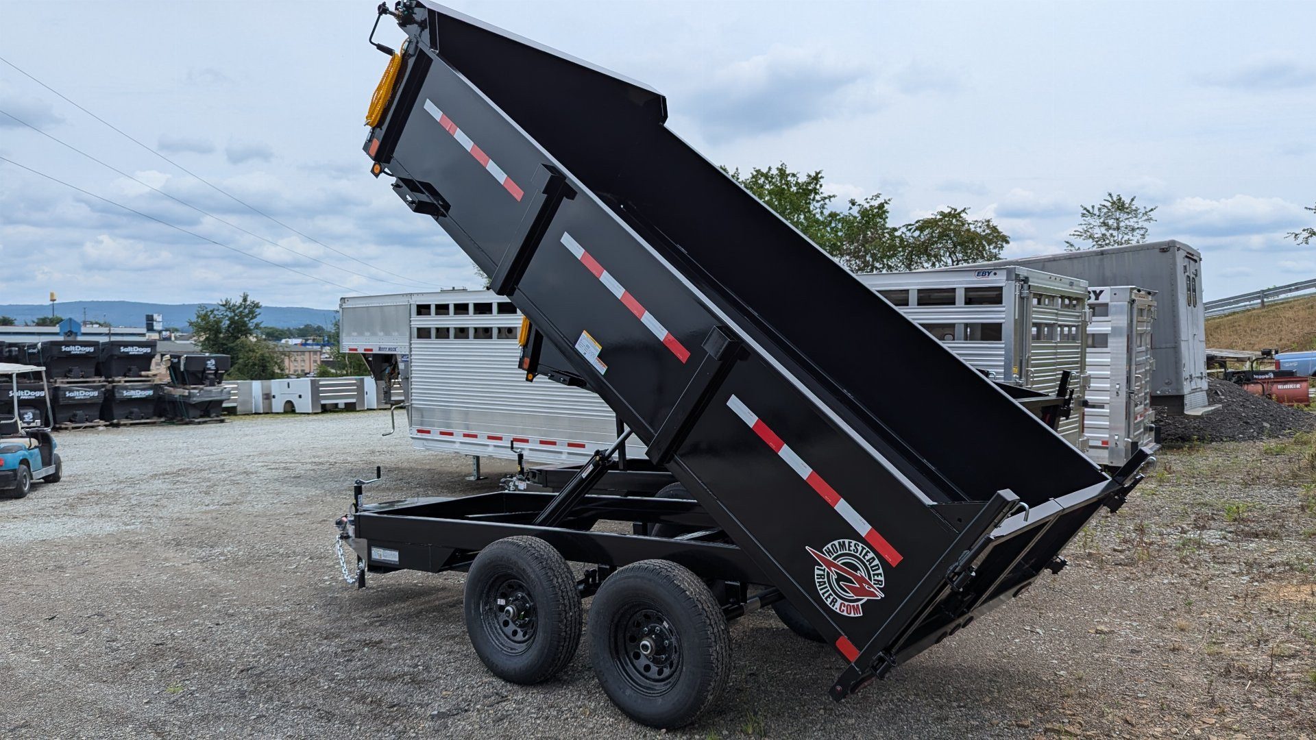 New 2025 Homesteader 6x12 Deckover Dump Trailer w/ Dropside on Curbside