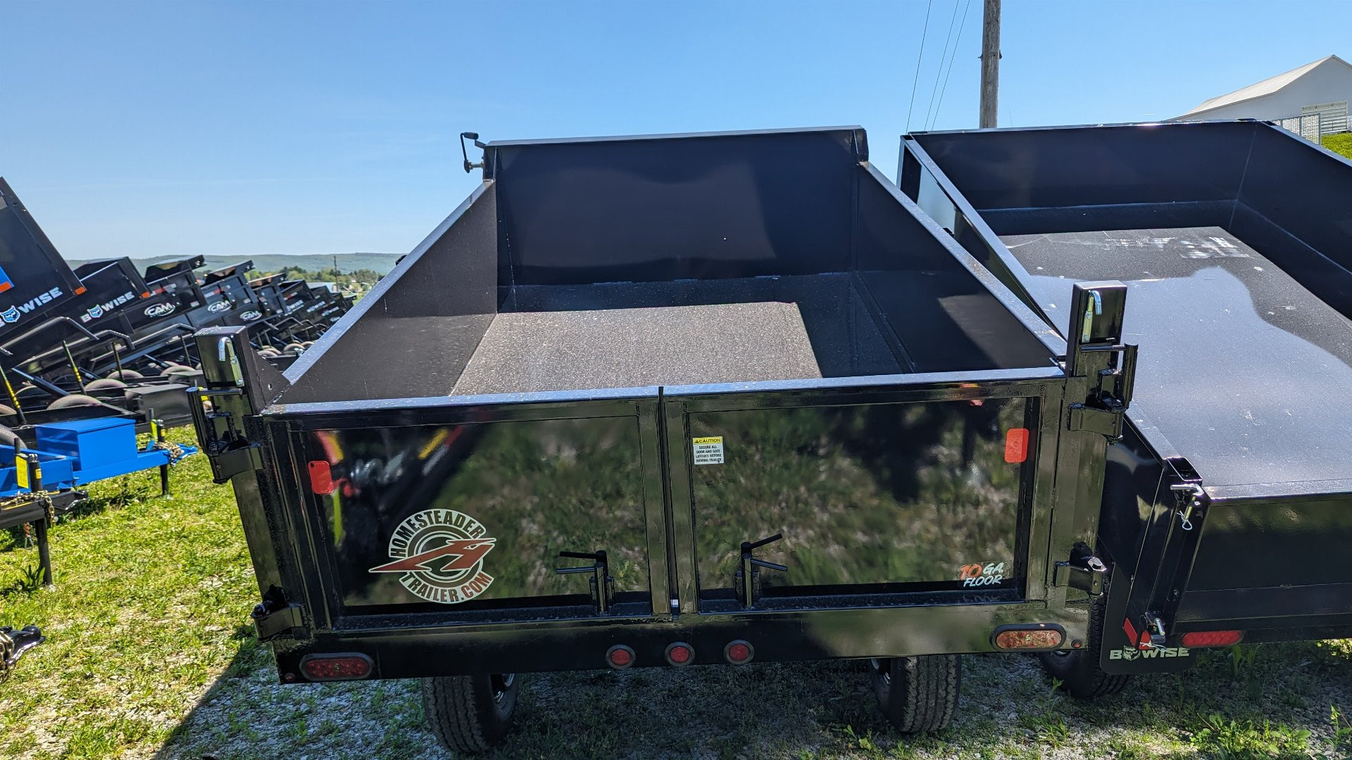 New 2025 Homesteader 6x12 Deckover Dump Trailer w/ Dropside on Curbside