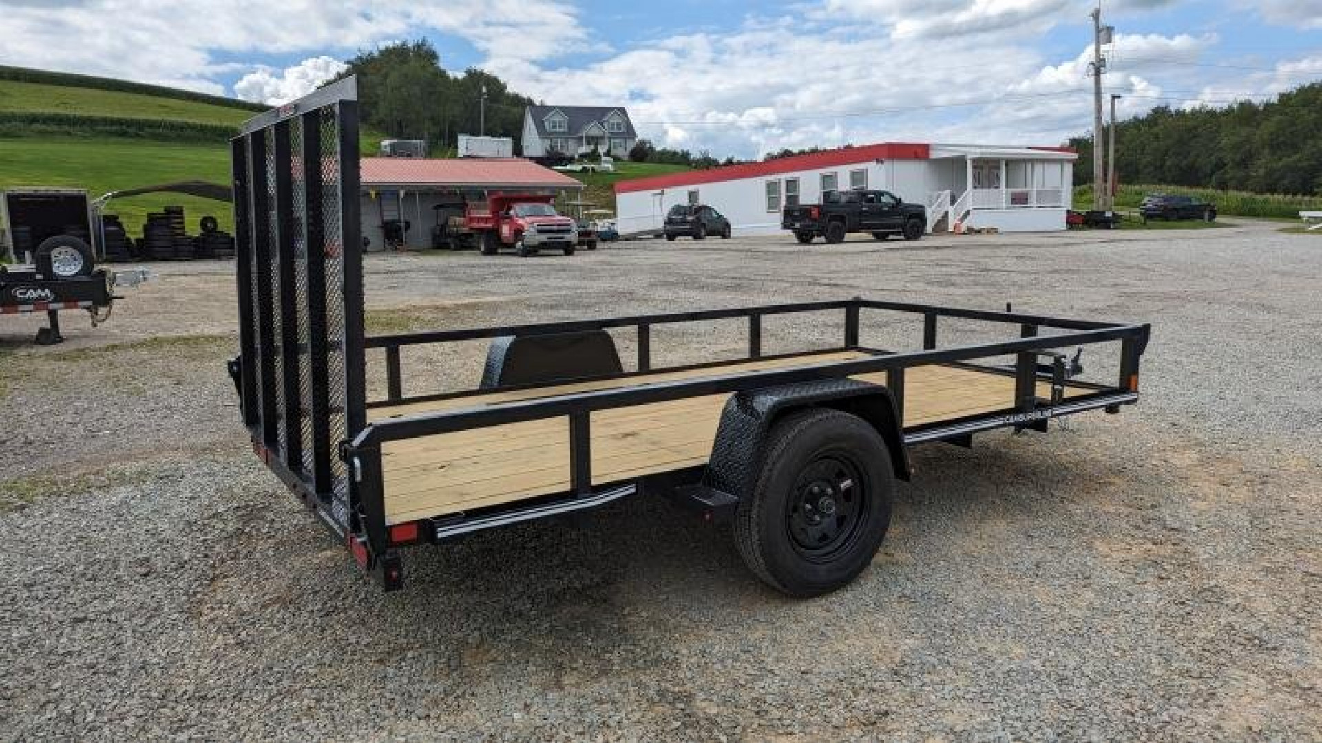 New 2025 CAM SUPERLINE 7x12 Tubular Top Rail Utility Trailer w/ Spring Assist/ Lay Down Ramp