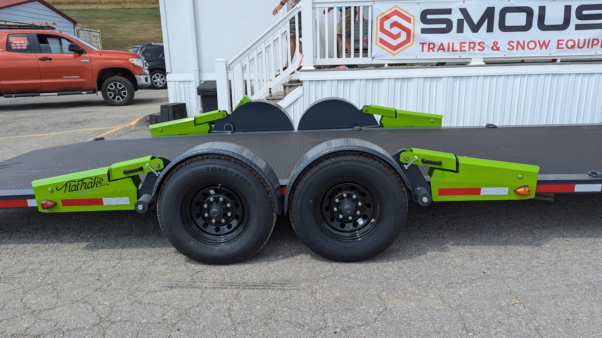 New 2025 FlatTrak by Belmont 7x22 HD Lay Flat Tilt Equipment Hauler w/ Hydraulic Jack