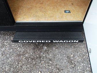 New 2025 COVERED WAGON TRAILERS 8.5x24 Cargo Trailer / Enclosed Cargo Trailer / Enclosed Car Hauler / 7ft Interior / 5200# Axles / Extra Wide Ramp Door / 48" RV Side Door / Bed Lined RV Step / .030 Black Semi-Screwless Exterior / Black Out Package