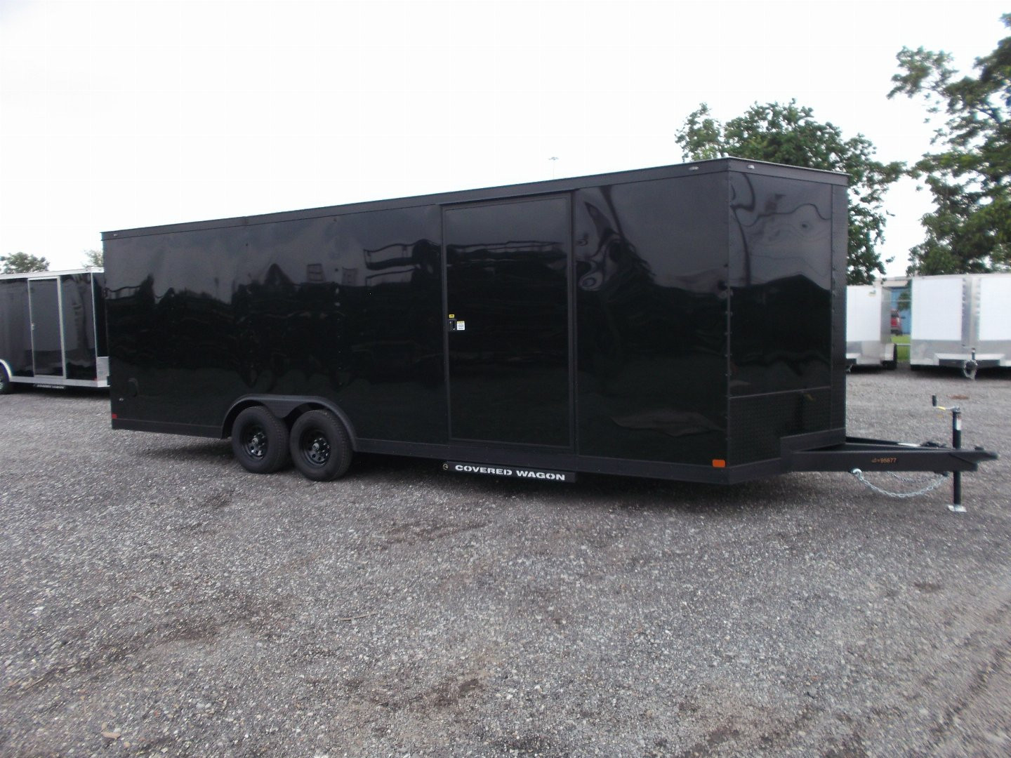 New 2025 COVERED WAGON TRAILERS 8.5x24 Cargo Trailer / Enclosed Car Hauler / 7ft Interior / 5200# Axles / Extra Wide Ramp Door / 48" RV Side Door / Bed Lined RV Step / .030 Black Semi-Screwless Exterior / Black Out Package