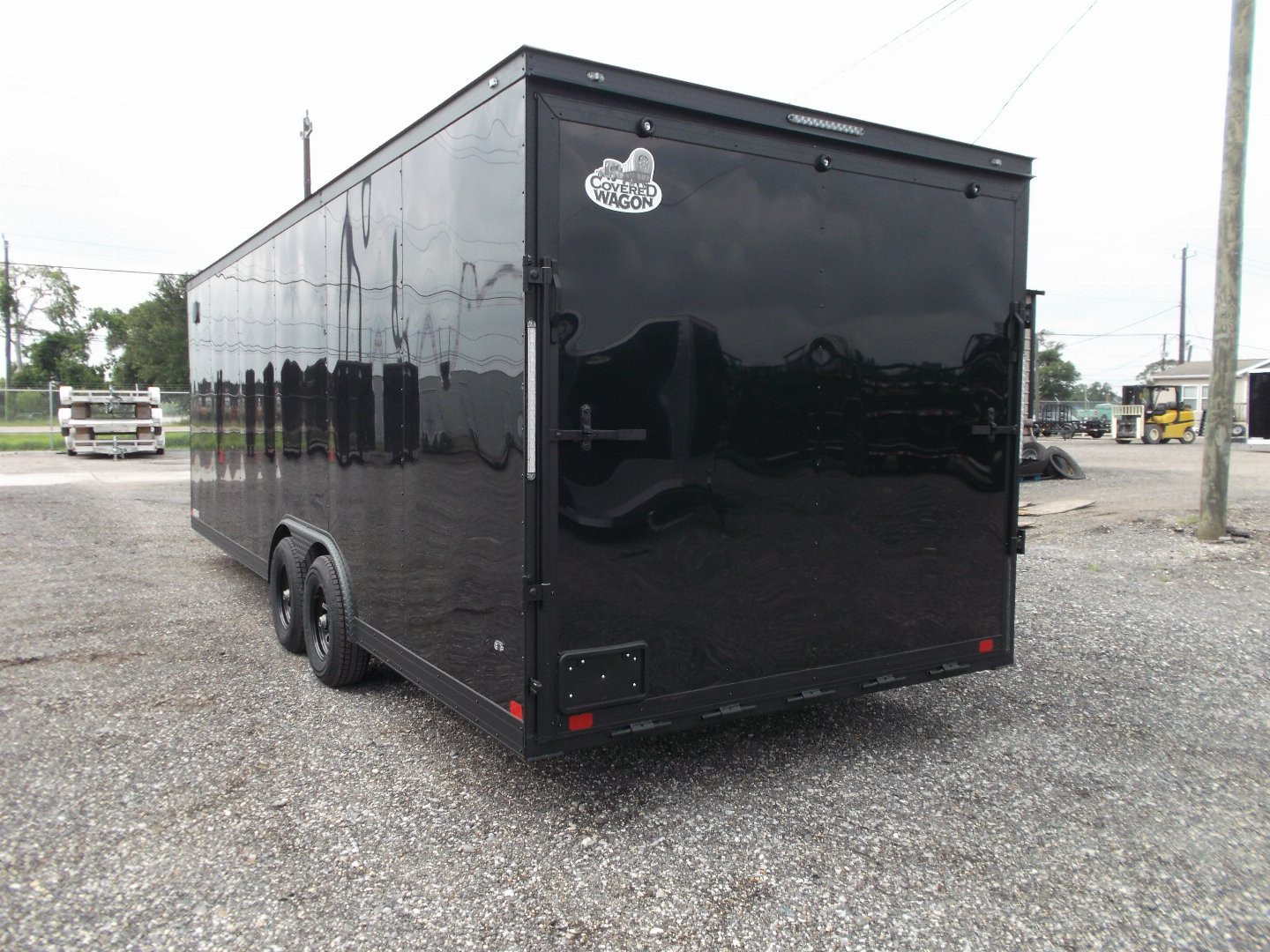 New 2025 COVERED WAGON TRAILERS 8.5x24 Cargo Trailer / Enclosed Car Hauler / 7ft Interior / 5200# Axles / Extra Wide Ramp Door / 48" RV Side Door / Bed Lined RV Step / .030 Black Semi-Screwless Exterior / Black Out Package