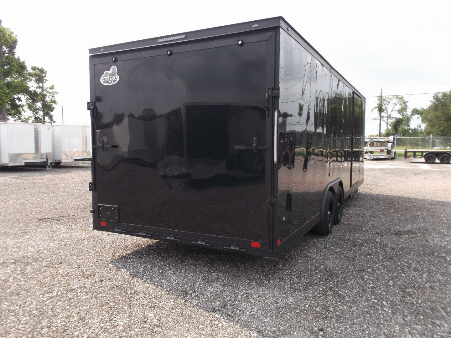 New 2025 COVERED WAGON TRAILERS 8.5x24 Cargo Trailer / Enclosed Car Hauler / 7ft Interior / 5200# Axles / Extra Wide Ramp Door / 48" RV Side Door / Bed Lined RV Step / .030 Black Semi-Screwless Exterior / Black Out Package