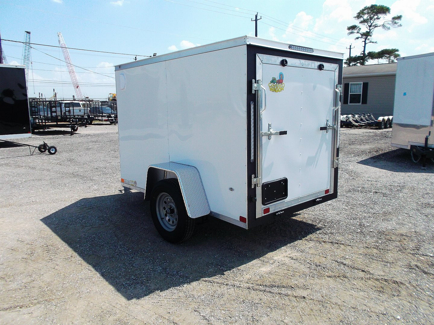 New 2025 COVERED WAGON TRAILERS 5x8 Cargo Trailer / Enclosed Cargo Trailer / Ramp / RV Side Door / Bed Lined Tongue and Frame / .030 White Semi-Screwless Exterior