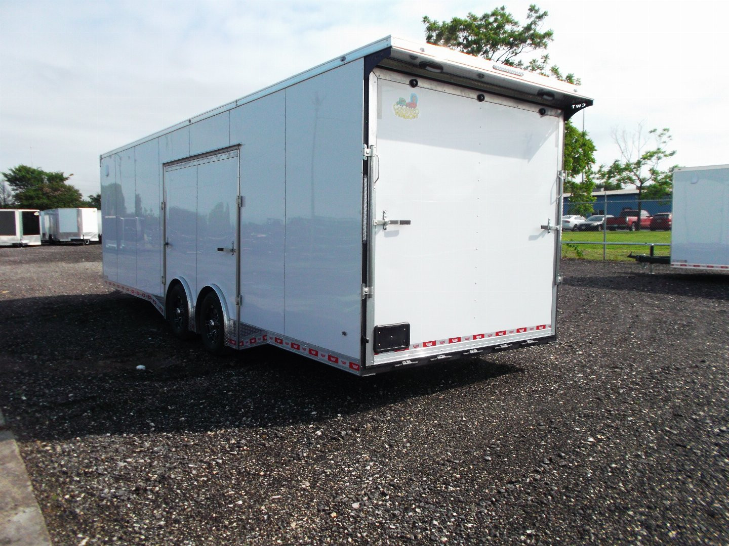 New 2025 COVERED WAGON 8.5x28 Enclosed Race Trailer / Cargo Trailer / XXL Package / 7'6" Interior Height / Split 7000# Torsion Axles / Heavy Duty Extra Wide Ramp / .080 White Poly Core Exterior / Mag Wheels / Rear Spoiler / Side Wall Escape Door