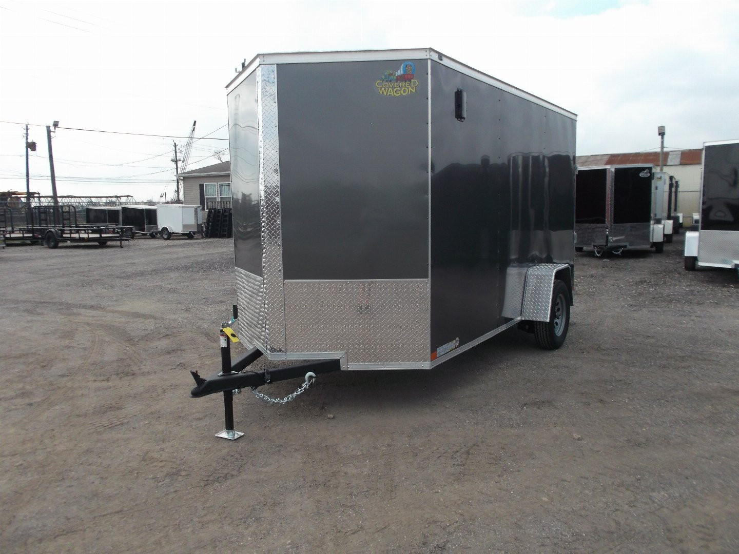 New 2025 Covered Wagon Trailers 6x12 SA Cargo Trailer / Enclosed Trailer / 6'6" Interior / 36" RV Side Door / Bed Lined Tongue and Frame / .030 Charcoal Gray Semi-Screwless Exterior / (4) D-Rings / Extra Wide Ramp