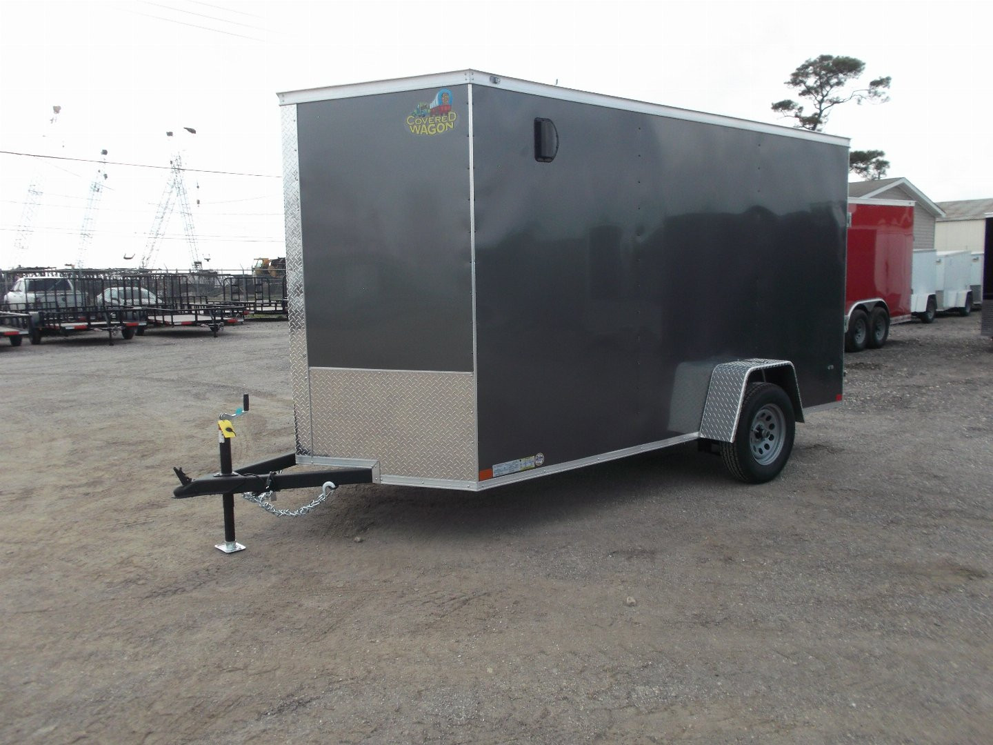 New 2025 Covered Wagon Trailers 6x12 SA Cargo Trailer / Enclosed Trailer / 6'6" Interior / 36" RV Side Door / Bed Lined Tongue and Frame / .030 Charcoal Gray Semi-Screwless Exterior / (4) D-Rings / Extra Wide Ramp