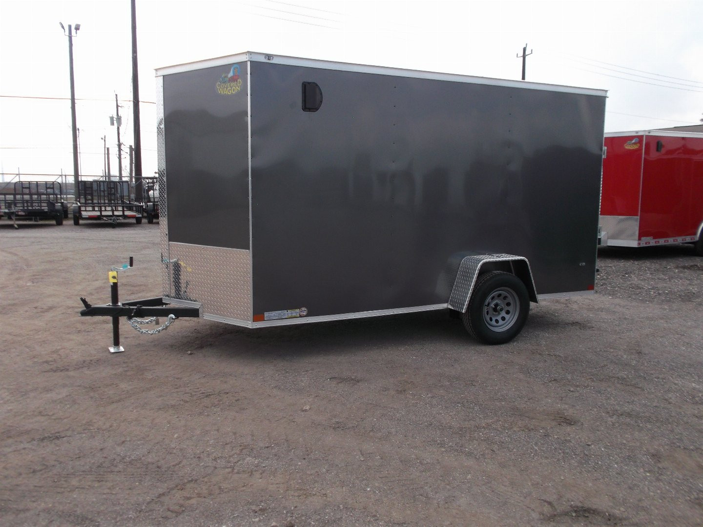 New 2025 Covered Wagon Trailers 6x12 SA Cargo Trailer / Enclosed Trailer / 6'6" Interior / 36" RV Side Door / Bed Lined Tongue and Frame / .030 Charcoal Gray Semi-Screwless Exterior / (4) D-Rings / Extra Wide Ramp