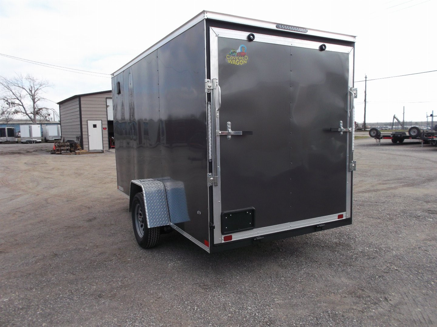 New 2025 Covered Wagon Trailers 6x12 SA Cargo Trailer / Enclosed Trailer / 6'6" Interior / 36" RV Side Door / Bed Lined Tongue and Frame / .030 Charcoal Gray Semi-Screwless Exterior / (4) D-Rings / Extra Wide Ramp
