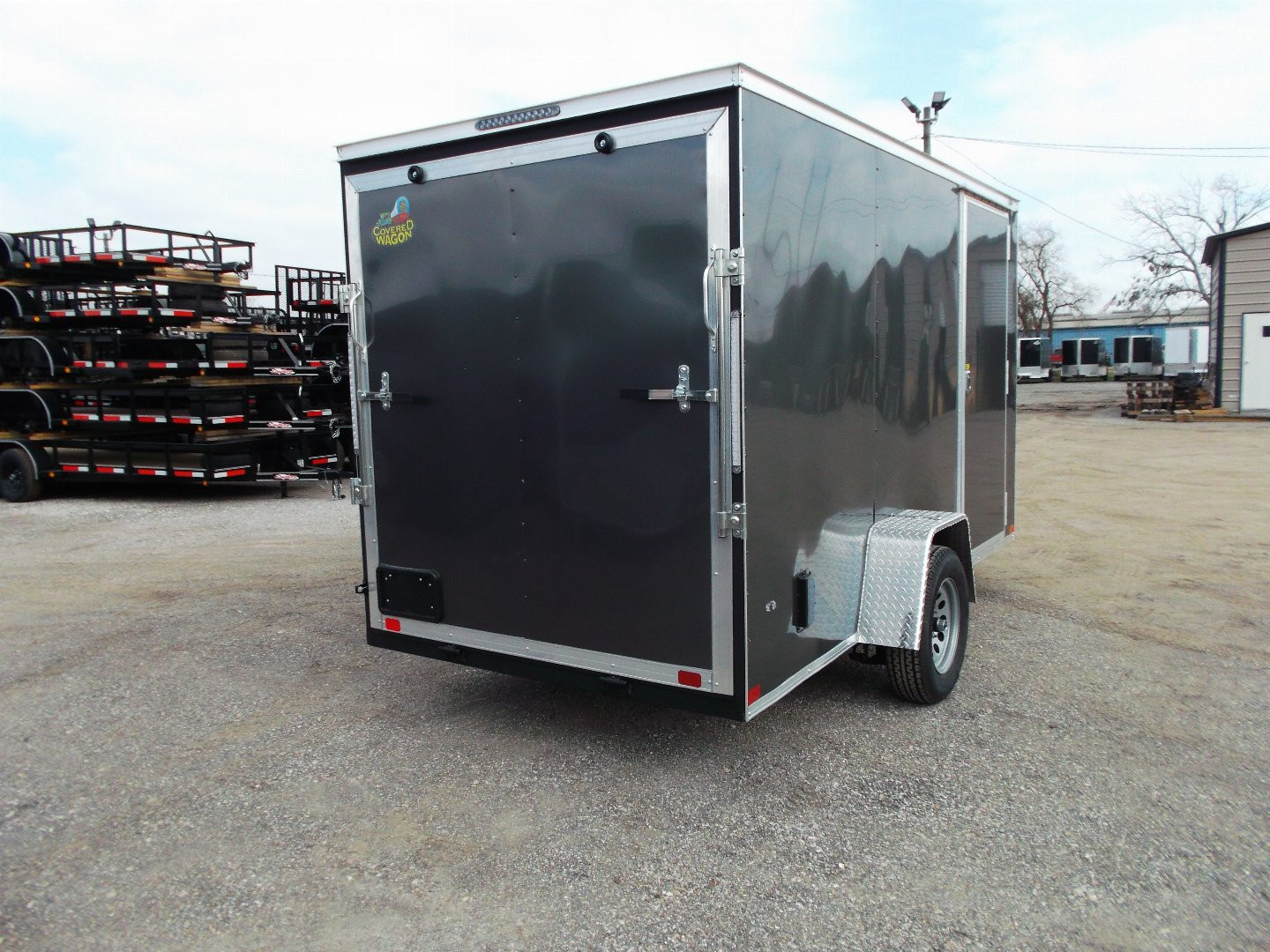 New 2025 Covered Wagon Trailers 6x12 SA Cargo Trailer / Enclosed Trailer / 6'6" Interior / 36" RV Side Door / Bed Lined Tongue and Frame / .030 Charcoal Gray Semi-Screwless Exterior / (4) D-Rings / Extra Wide Ramp