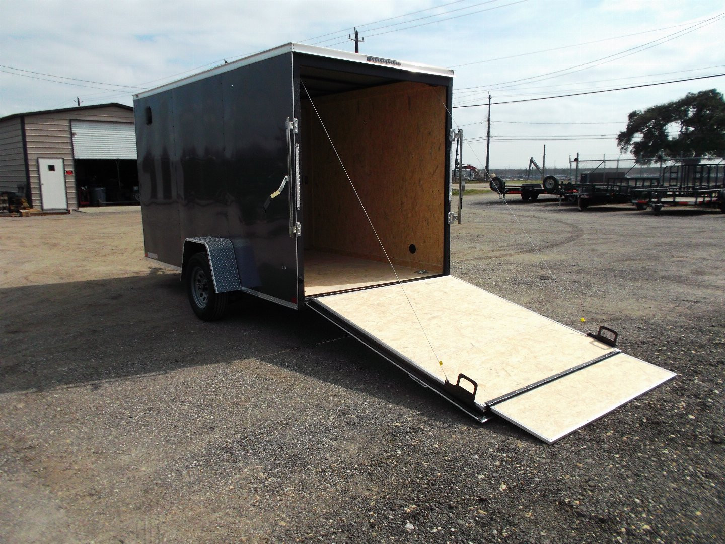 New 2025 Covered Wagon Trailers 6x12 SA Cargo Trailer / Enclosed Trailer / 6'6" Interior / 36" RV Side Door / Bed Lined Tongue and Frame / .030 Charcoal Gray Semi-Screwless Exterior / (4) D-Rings / Extra Wide Ramp