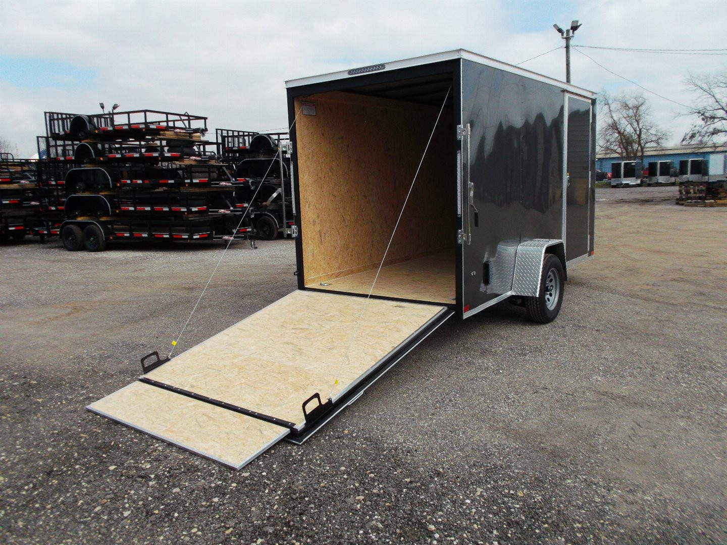 New 2025 Covered Wagon Trailers 6x12 SA Cargo Trailer / Enclosed Trailer / 6'6" Interior / 36" RV Side Door / Bed Lined Tongue and Frame / .030 Charcoal Gray Semi-Screwless Exterior / (4) D-Rings / Extra Wide Ramp