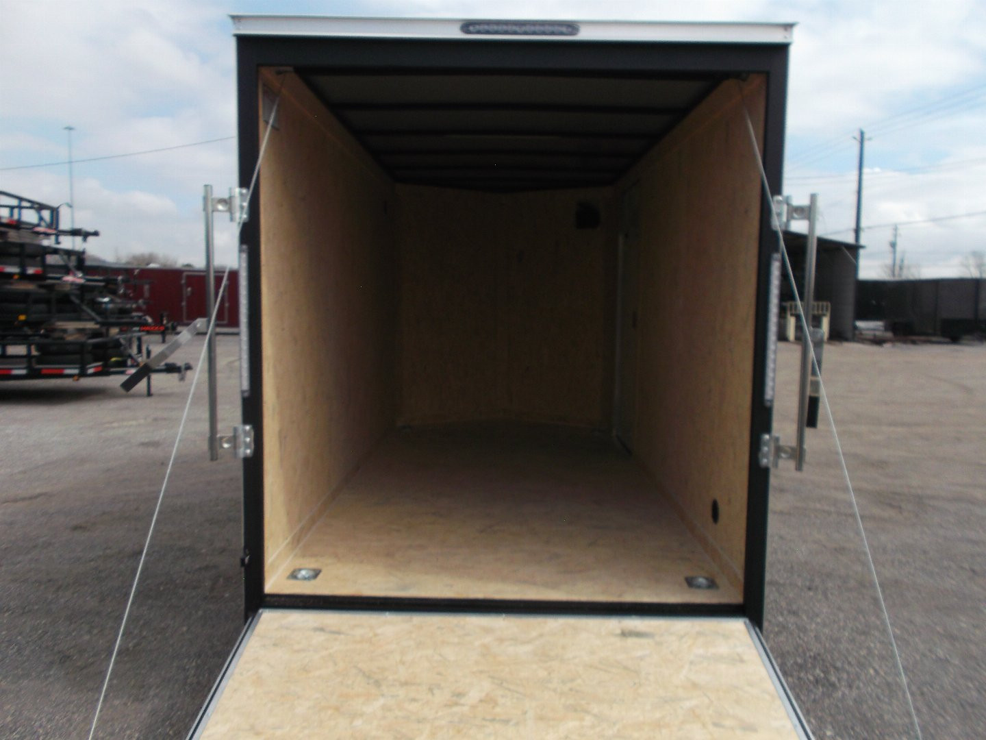 New 2025 Covered Wagon Trailers 6x12 SA Cargo Trailer / Enclosed Trailer / 6'6" Interior / 36" RV Side Door / Bed Lined Tongue and Frame / .030 Charcoal Gray Semi-Screwless Exterior / (4) D-Rings / Extra Wide Ramp