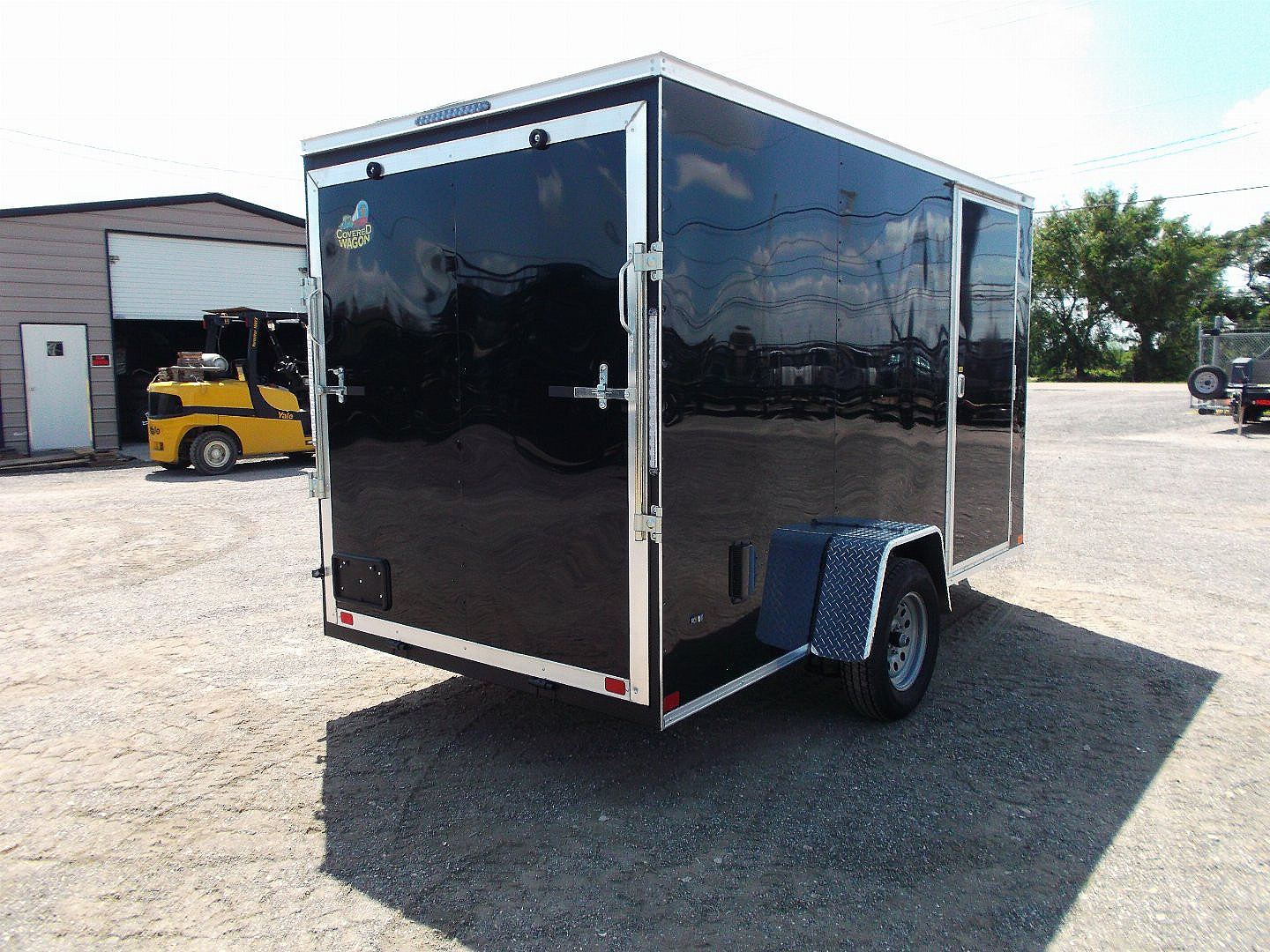 New 2025 Covered Wagon Trailers 6x12 SA Cargo / Enclosed Trailer / Extra Wide Ramp / 36" RV Side Door / 6'6" Interior / Bed Lined Tongue and Frame / (4) D-Rings / .030 Black Semi-Screwless Exterior