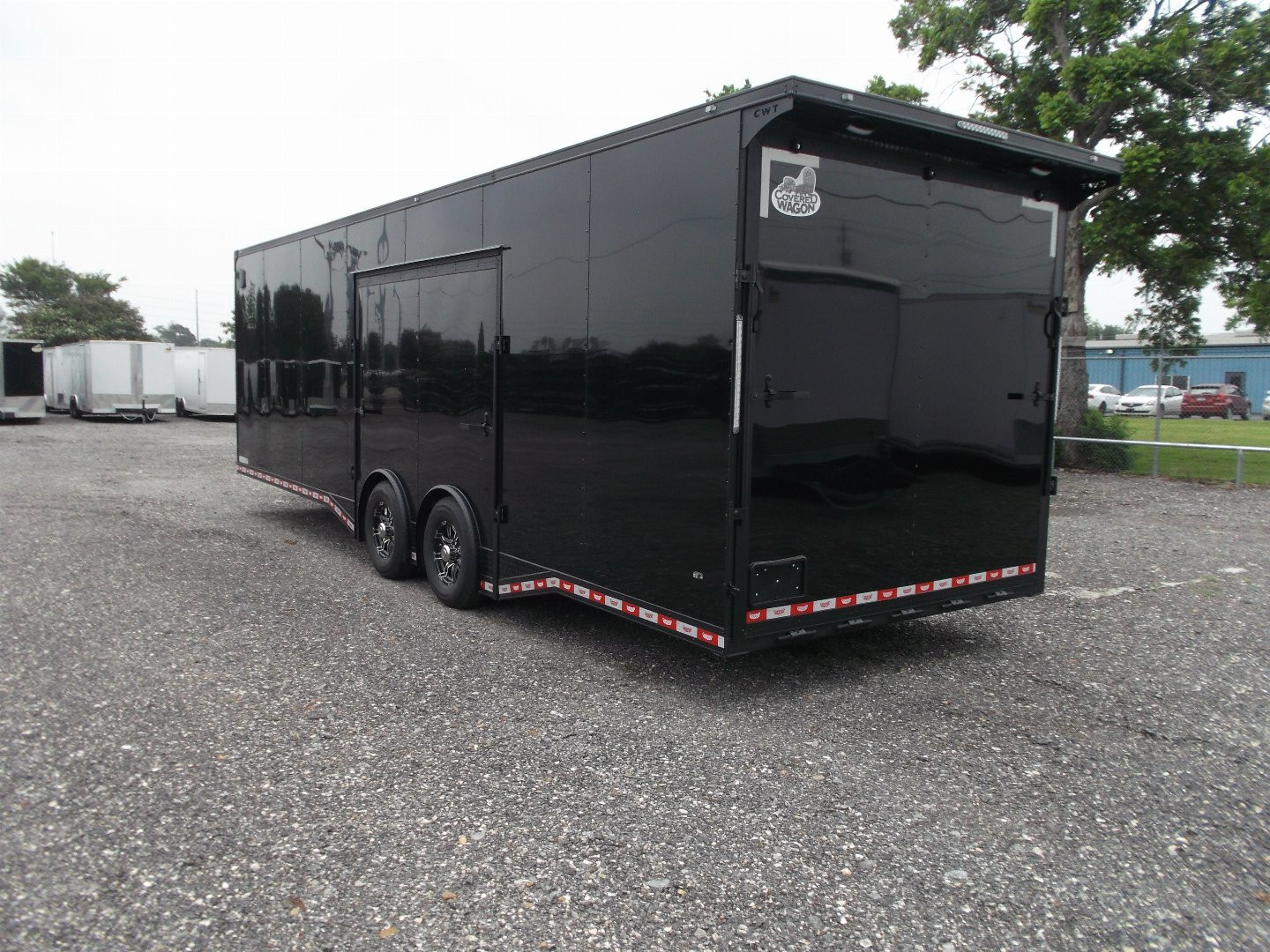 New 2025 COVERED WAGON TRAILERS 8.5x28 Race Trailer / Cargo Trailer / XXL Package / 7'6" Interior Height / Split 7000# Torsion Axles / Heavy Duty Extra Wide Ramp / .080 Black Poly Core / Black Out Package