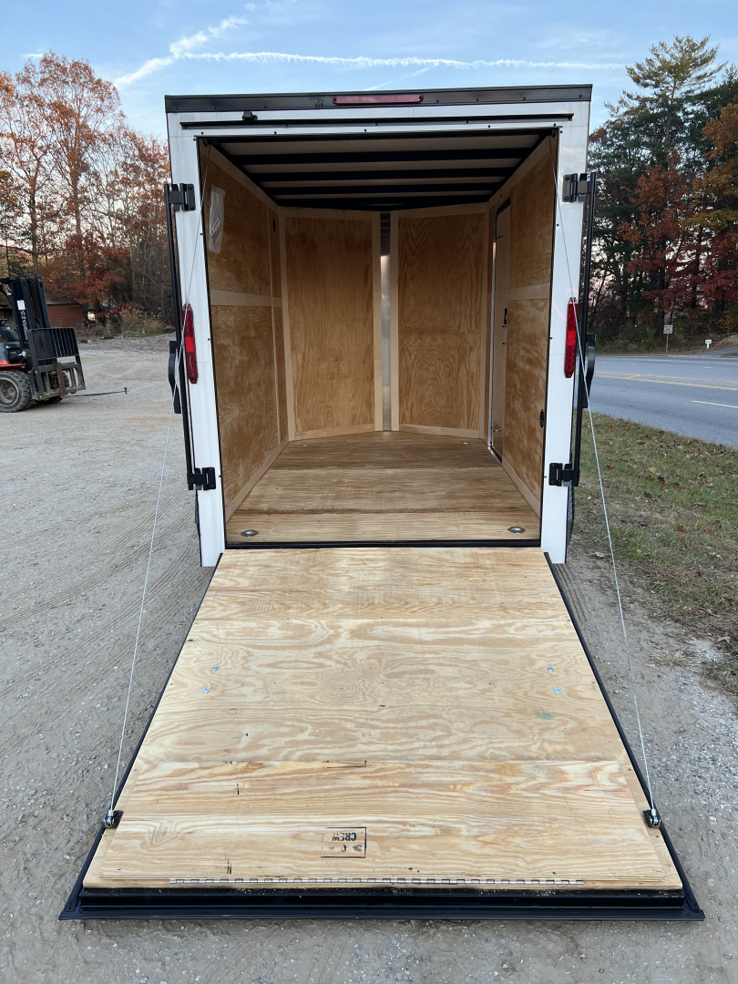 New 2026 HOMESTEADER TRAILER / INTREPID SERIES / 6' WIDE X 10' LONG / 6'6" INTERIOR HEIGHT / .030 WHITE ALUMINUM W/ BLACK OUT PKG / 32" SIDE DOOR W/ RV LOCK / RAMP REAR DOOR / 4-D RINGS / 16" O/C WALL POST