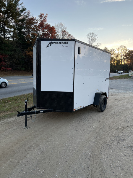 New 2026 HOMESTEADER TRAILER / INTREPID SERIES / 6' WIDE X 10' LONG / 6'6  INTERIOR HEIGHT / .030 WHITE ALUMINUM W/ BLACK OUT PKG / 32  SIDE DOOR W/ RV LOCK / RAMP REAR DOOR / 4-D RINGS / 16  O/C WALL POST