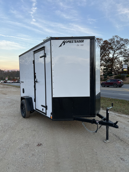 New 2026 HOMESTEADER TRAILER / INTREPID SERIES / 6' WIDE X 10' LONG / 6'6" INTERIOR HEIGHT / .030 WHITE ALUMINUM W/ BLACK OUT PKG / 32" SIDE DOOR W/ RV LOCK / RAMP REAR DOOR / 4-D RINGS / 16" O/C WALL POST