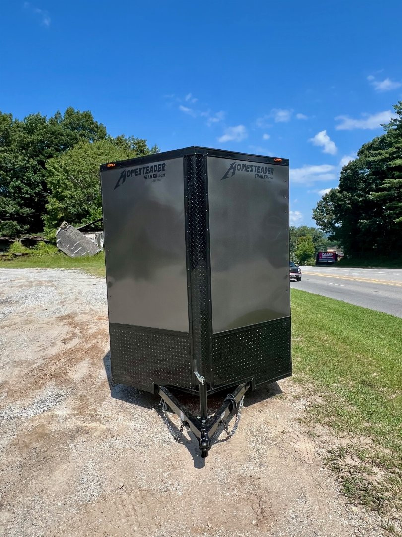 New 2025 HOMESTEADER TRAILER / INTREPID SERIES / 6' WIDE X 12' LONG / 6'6" INTERIOR HEIGHT / .030 CHARCOAL GRAY ALUMINUM W/ BLACK OUT PKG / 32" SIDE DOOR W/ RV LOCK / RAMP REAR DOOR / 4-D RINGS / 16" O/C WALL POST