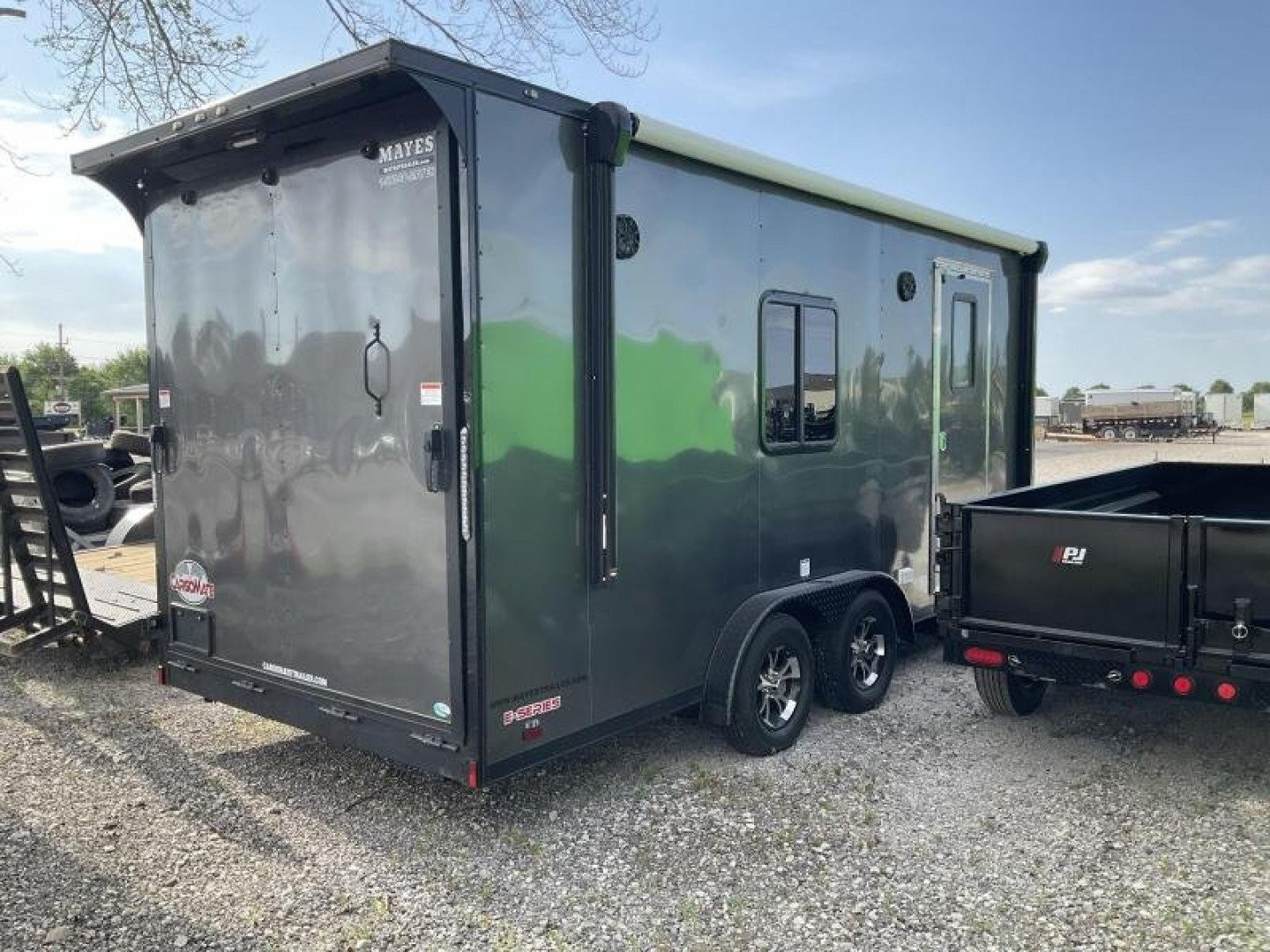 New 2022 Cargo Mate EHW718TA2 Enclosed Cargo<br />
Factory Demo<br />
No miles other than shipping<br />
7x18 TA RAMP DOOR (GVW:7000)<br />
Camper Model<br />
Pop Out Camper side mounted bed <br />
110 Power<br />
Toilet and Sink <br />
Wet Sounds Stereo