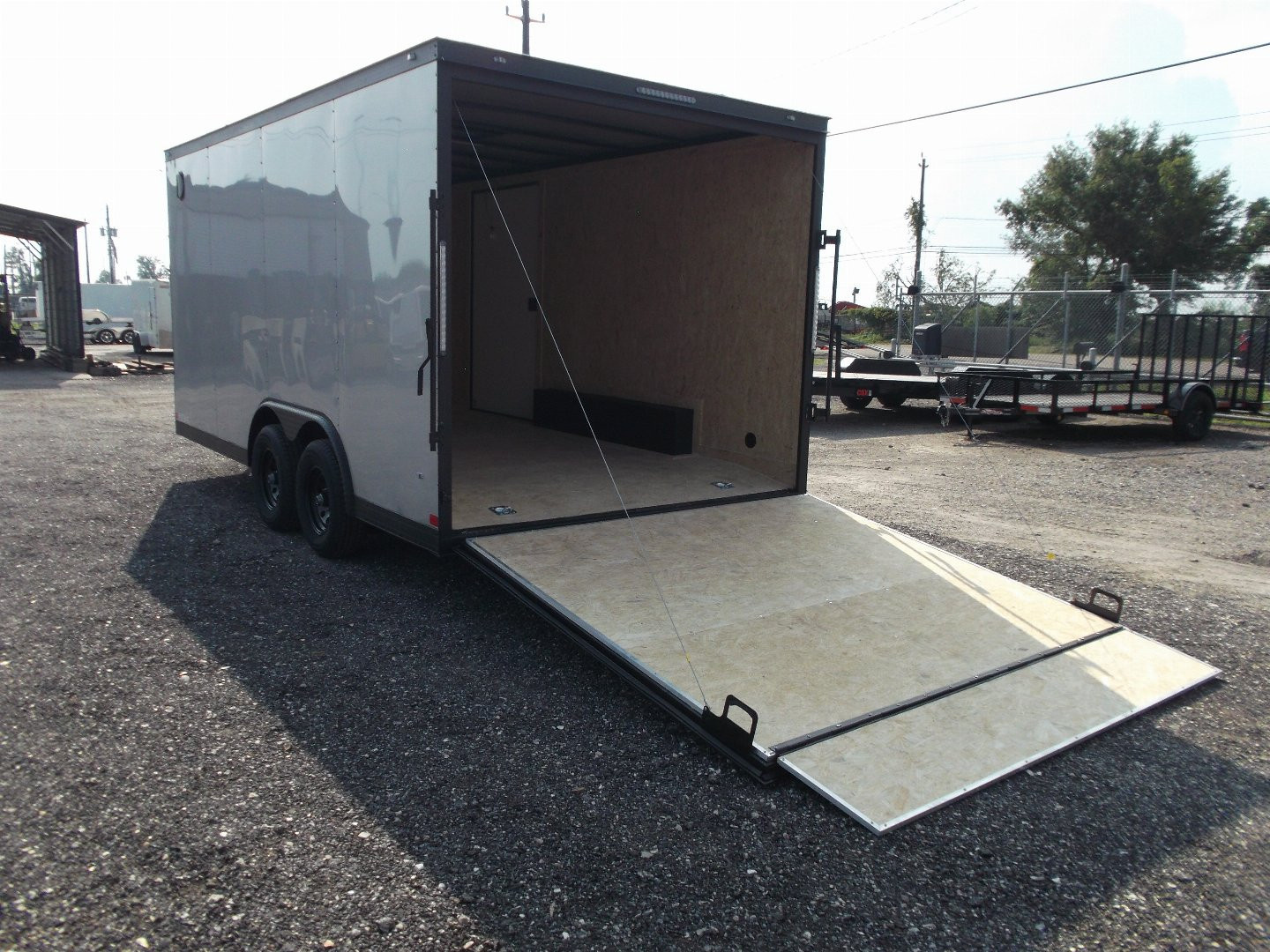 New 2026 Covered Wagon Trailers 8.5x16 Cargo Trailer / Car Hauler / 5200# Axles / 7ft Interior Height / 48" RV Side Door / Bed Lined RV Step / .030 Silver Semi-Screwless Exterior / 60" Triple Tube Tongue / Extra Wide Ramp / Black Out Package