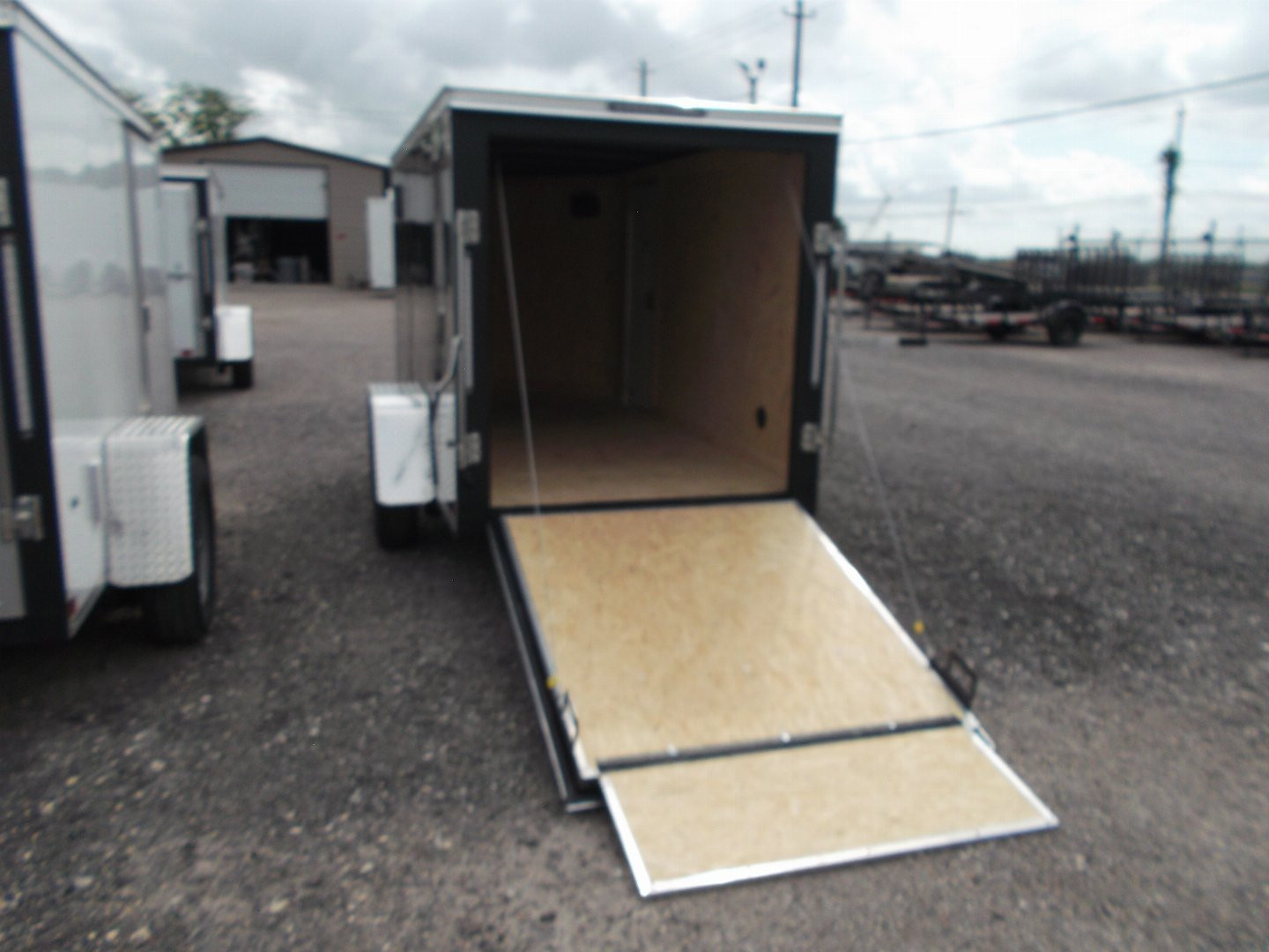 New 2026 Covered Wagon Trailers 5x10 Single Axle Cargo Trailer / Enclosed Cargo Trailer / Ramp / RV Side Door / Bed Lined Tongue and Frame / .030 Black Semi-Screwless Exterior