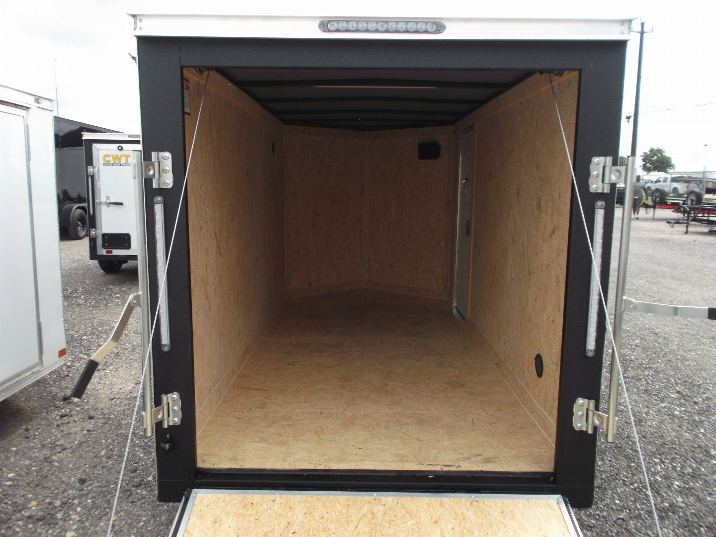 New 2026 Covered Wagon Trailers 5x10 Single Axle Cargo Trailer / Enclosed Cargo Trailer / Ramp / RV Side Door / Bed Lined Tongue and Frame / .030 Black Semi-Screwless Exterior