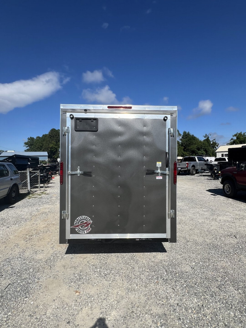 New 2025 Homesteader Trailer / 610IS Cargo / Enclosed Trailer / 6'6" Interior Height / Charcoal Gray in color / Side Door w/ RV Door Lock and Ramp Rear Door
