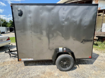 New 2026 HOMESTEADER TRAILER / INTREPID SERIES / 6' WIDE X 10' LONG / 6'6" INTERIOR HEIGHT / .030 CHARCOAL GRAY ALUMINUM W/ BLACK OUT PKG / 32" SIDE DOOR W/ RV LOCK / RAMP REAR DOOR / 4-D RINGS / 16" O/C WALL POST