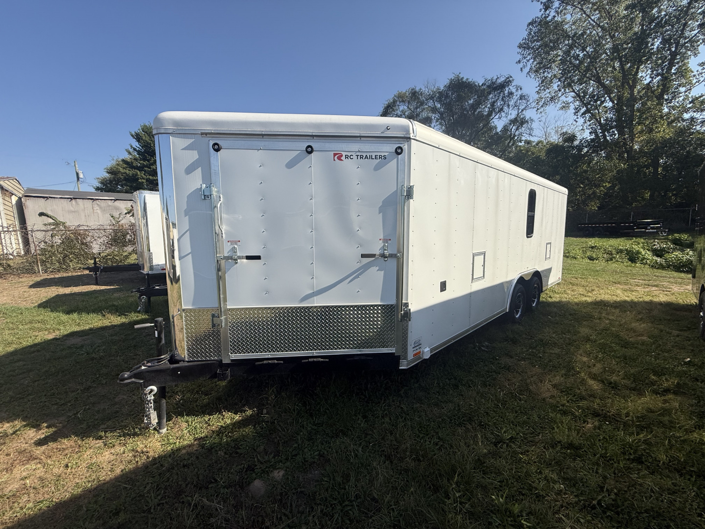 New RC Trailers 8.5x25 10k snow/car hauler,torsion axles with alum. Wheels,5' wedge nose,30 amp sevice with cord,12 volt battery,4' caninet,2 windows an fuel doors, round top