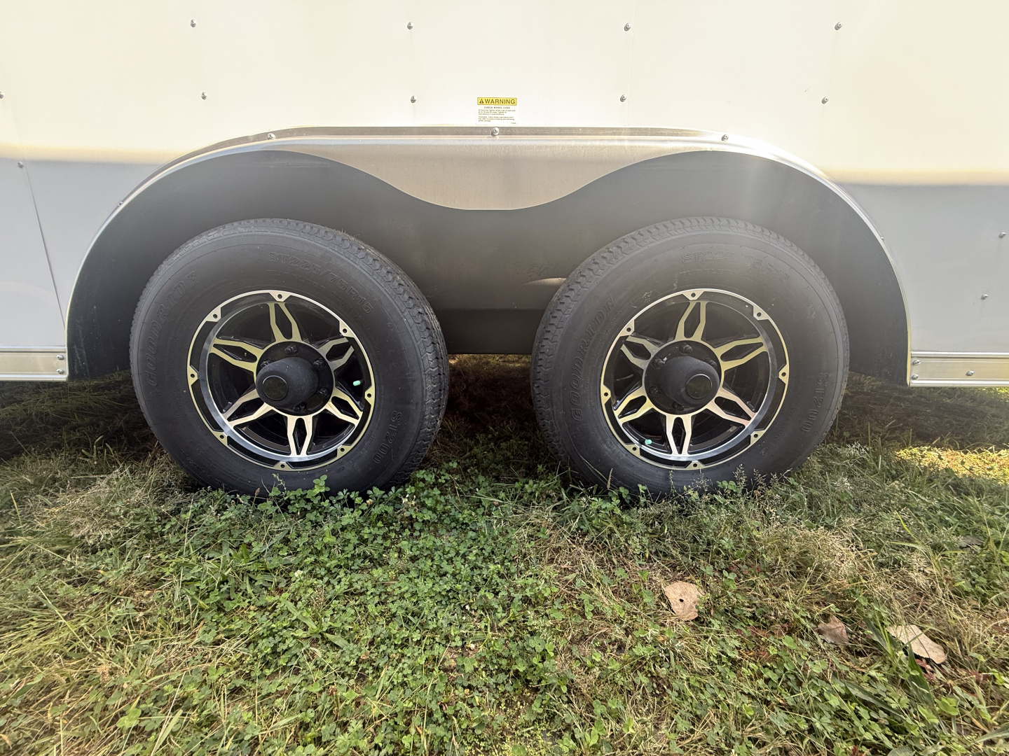 New RC Trailers 8.5x25 10k snow/car hauler,torsion axles with alum. Wheels,5' wedge nose,30 amp sevice with cord,12 volt battery,4' caninet,2 windows an fuel doors, round top