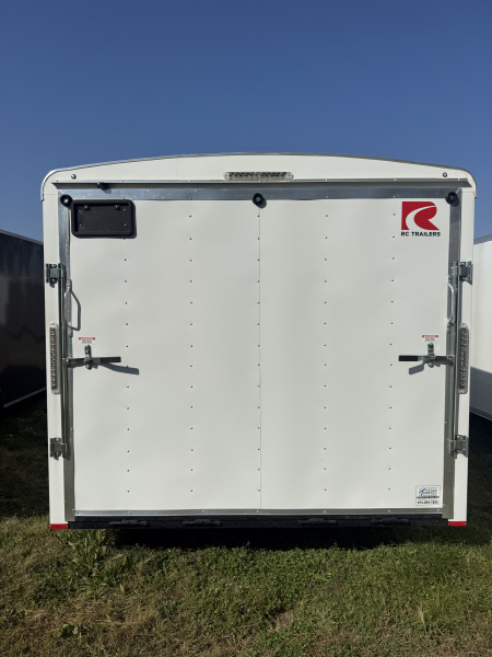 New RC Trailers 8.5x25 10k snow/car hauler,torsion axles with alum. Wheels,5' wedge nose,30 amp sevice with cord,12 volt battery,4' caninet,2 windows an fuel doors, round top