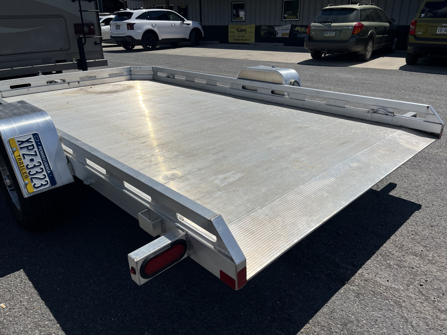 Used 2025 USED Aluma 7712H Tilt Utility Trailer