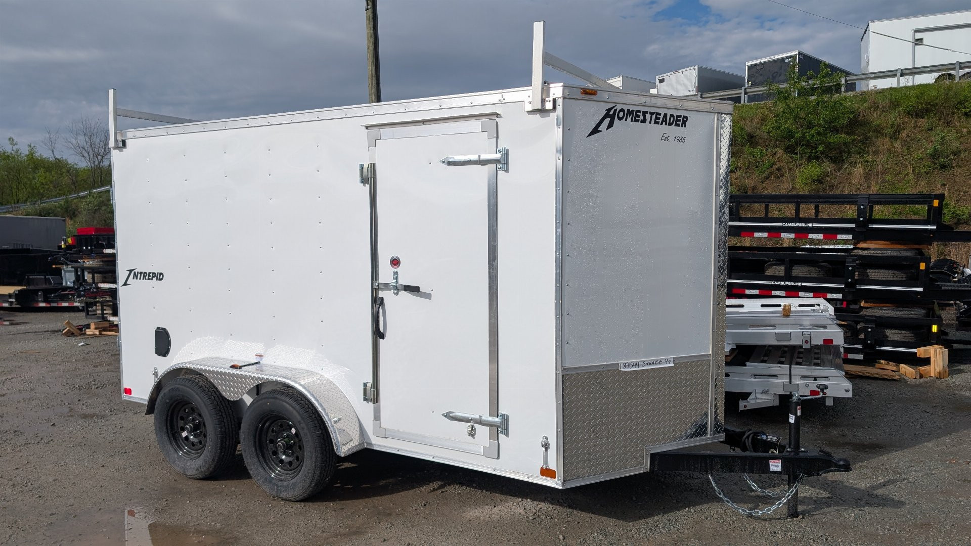 New 2026 Homesteader 6x12 Tandem Intrepid V-Nose Contractor Trailer w/ Rear Barn Doors & Ladder Racks