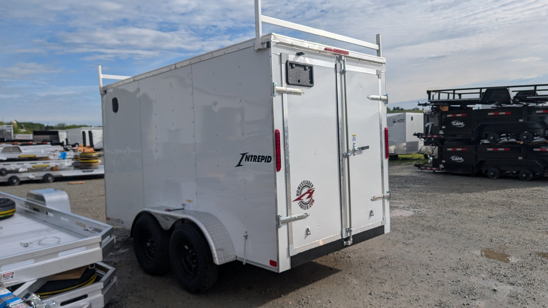 New 2026 Homesteader 6x12 Tandem Intrepid V-Nose Contractor Trailer w/ Rear Barn Doors & Ladder Racks