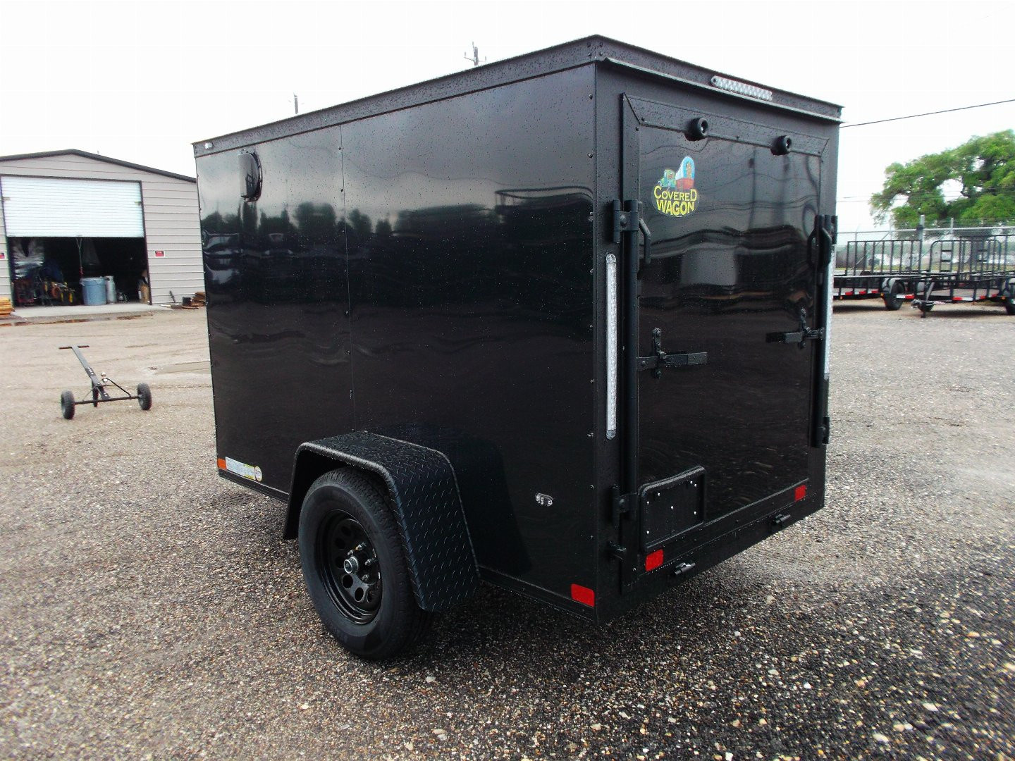 New 2026 Covered Wagon Trailers 5x8 Cargo Trailer / Enclosed Trailer / Ramp / Side Door / .030 Black Semi-Screwless Exterior / Bed Lined Tongue and Frame / Black Out Package